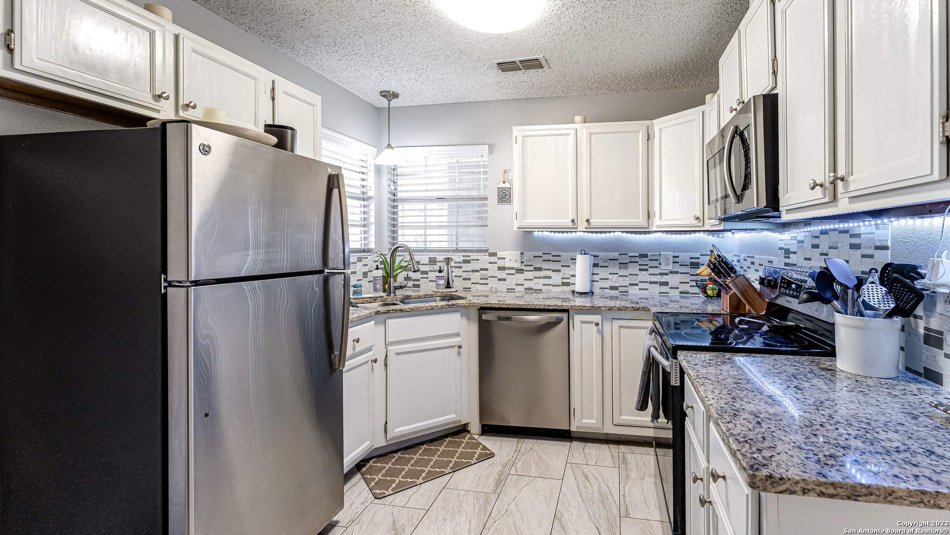 3309 Country View Schertz, TX 78108 - Photo 12 of 27 a kitchen with stainless steel appliances granite countertop a refrigerator sink and cabinets