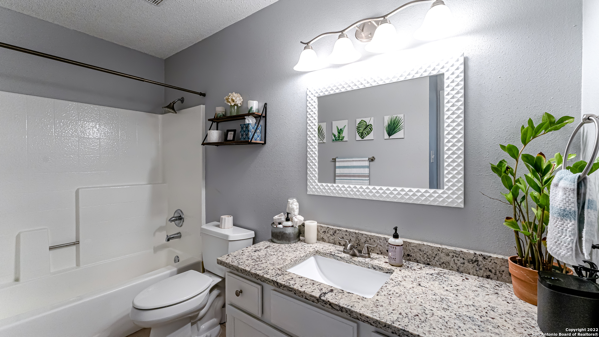 3309 Country View Schertz, TX 78108 - Photo 21 of 27 a bathroom with a granite countertop sink a toilet and shower