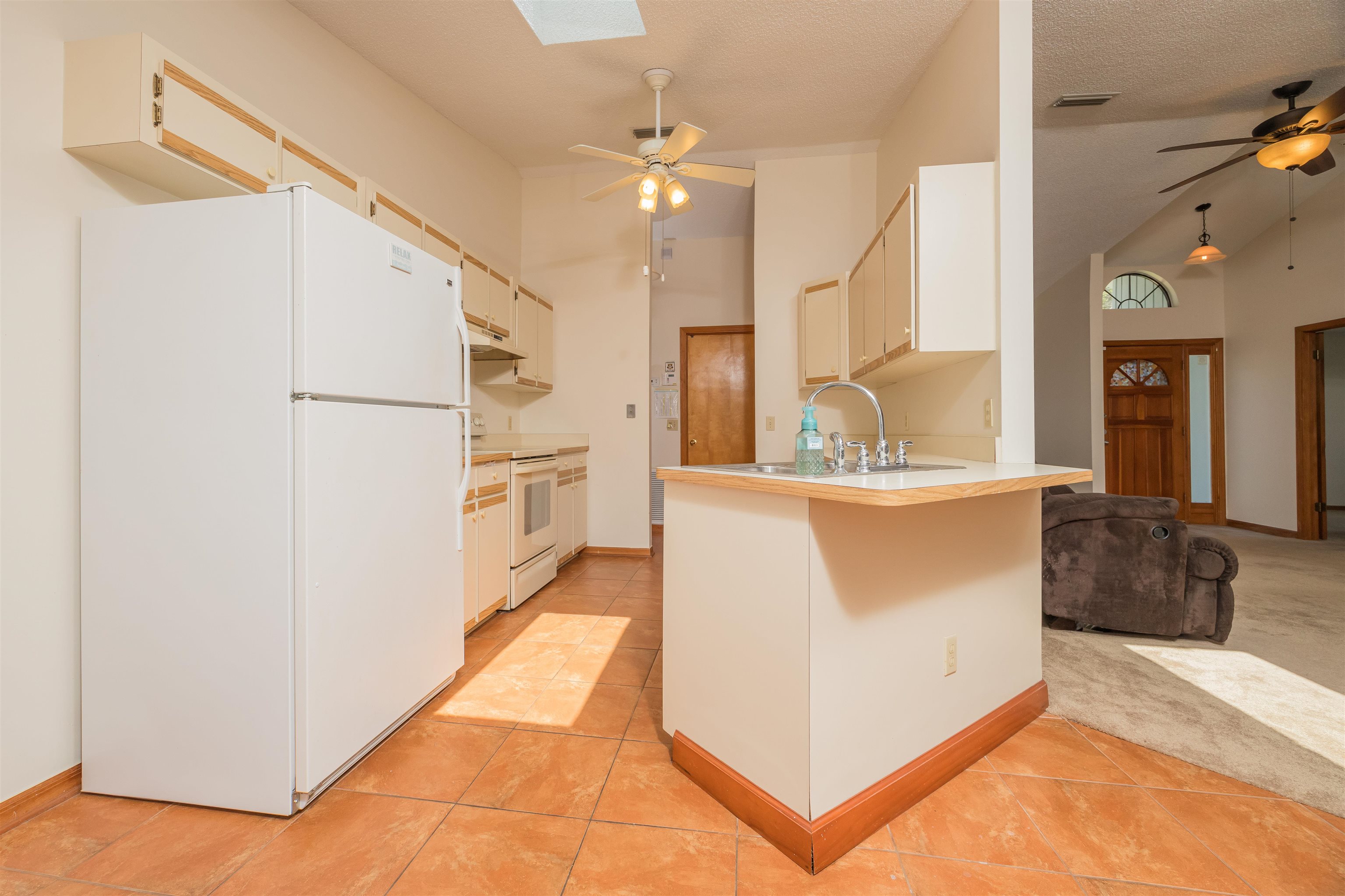 836 Queen Road St. Augustine, FL 32086 - Photo 11 of 26 a view of kitchen with cabinets and refrigerator