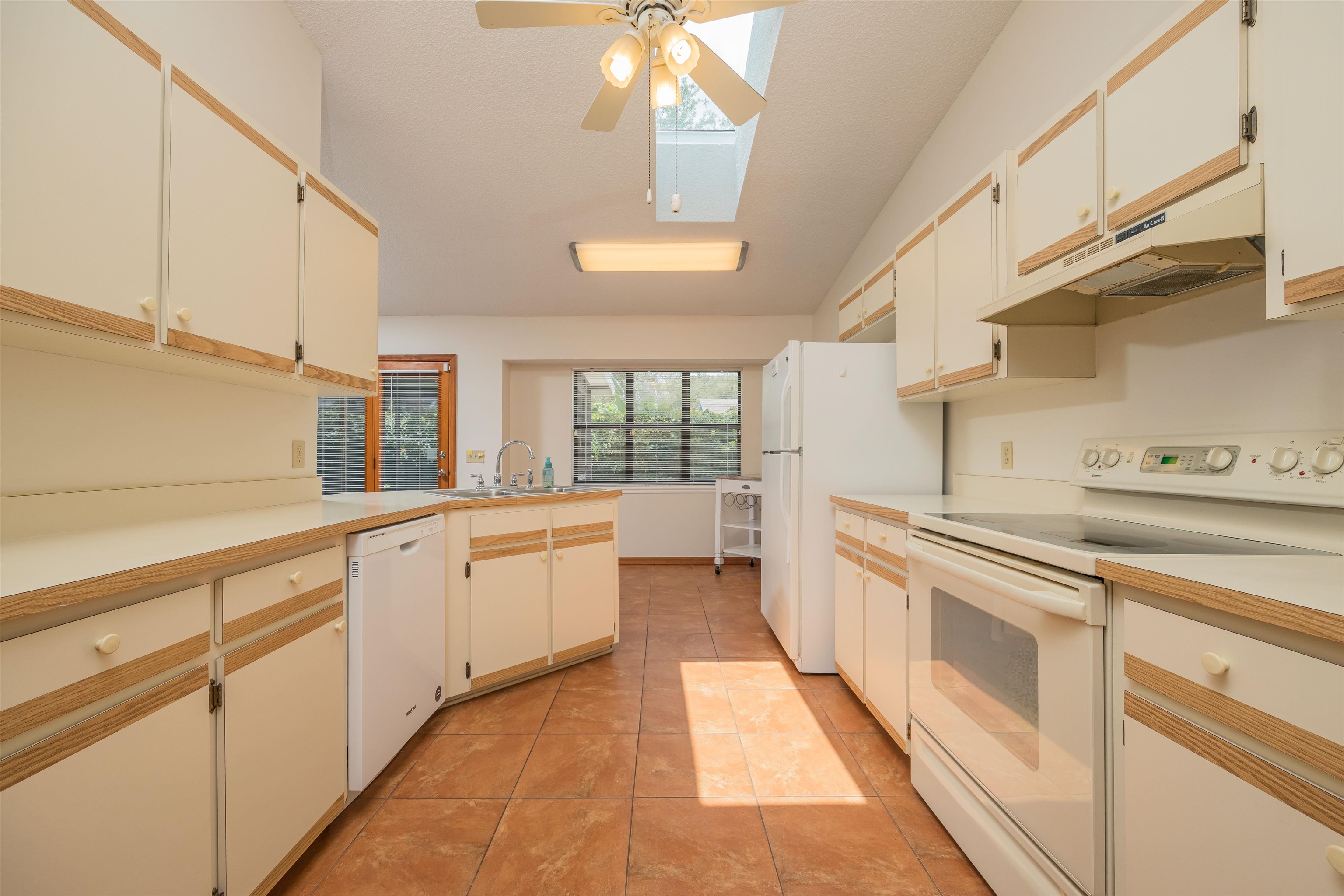 836 Queen Road St. Augustine, FL 32086 - Photo 12 of 26 a large white kitchen with cabinets a sink a stove and a window