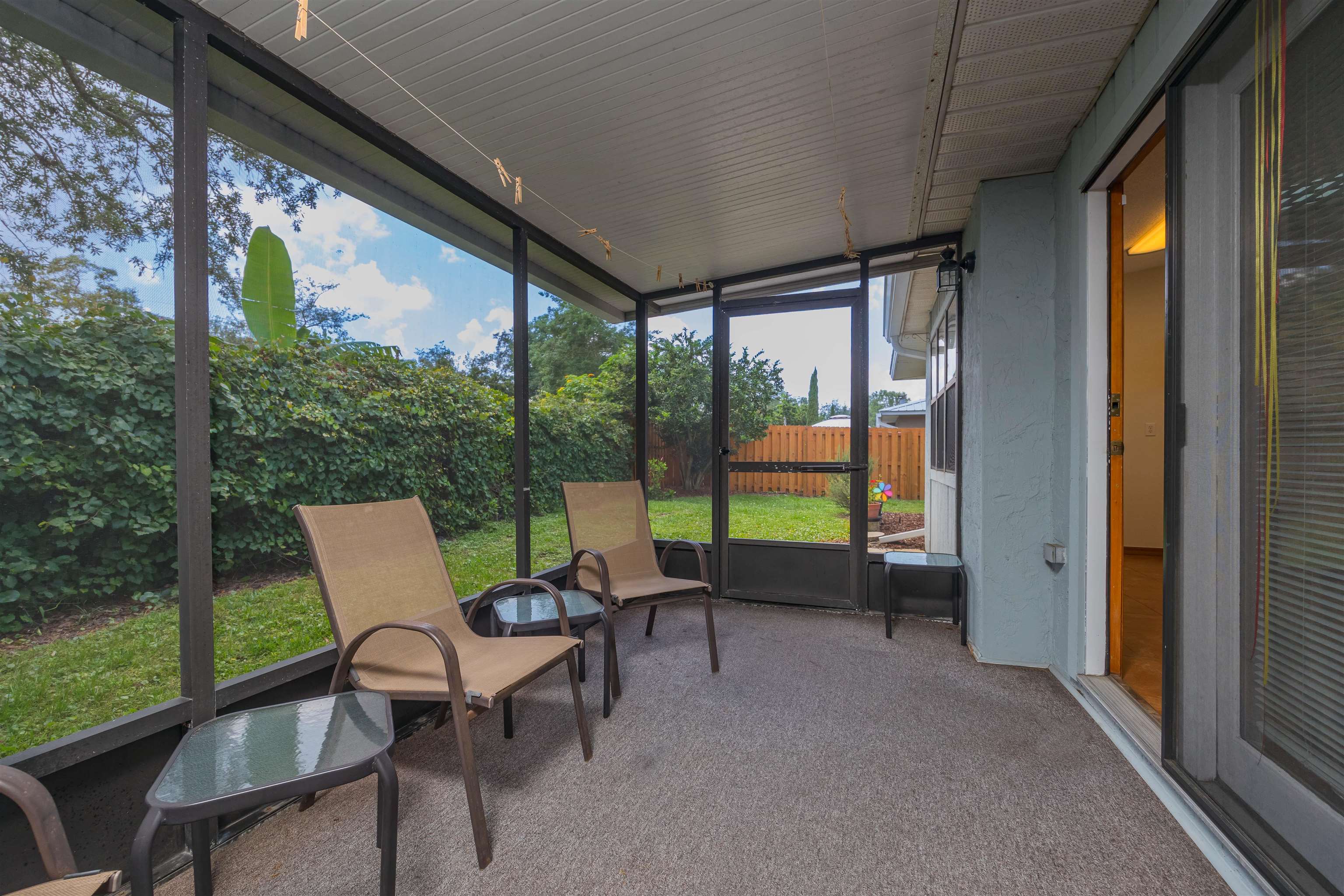 836 Queen Road St. Augustine, FL 32086 - Photo 13 of 26 a view of a chairs and table in patio with a yard