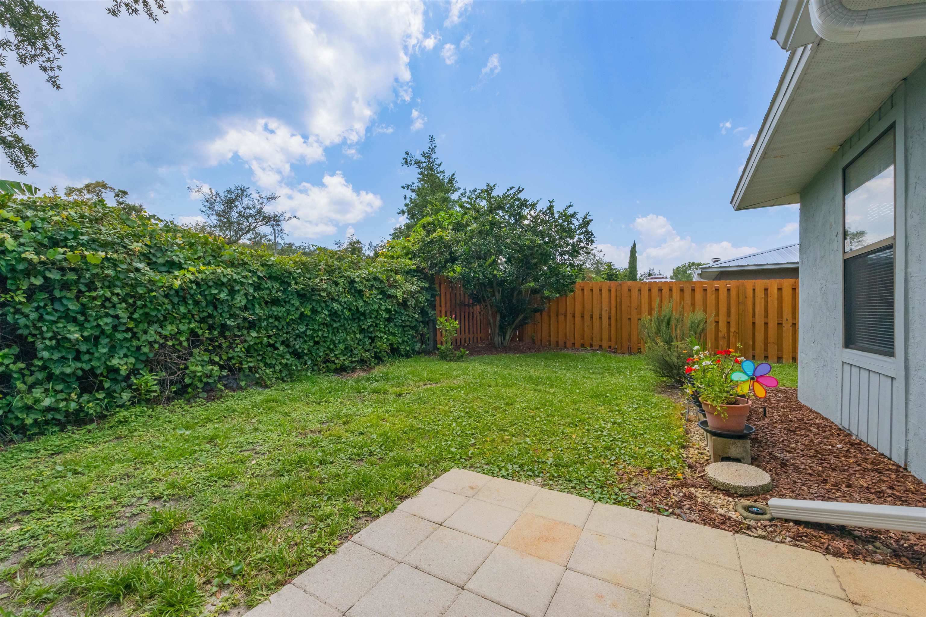 836 Queen Road St. Augustine, FL 32086 - Photo 15 of 26 a view of a backyard with sitting area
