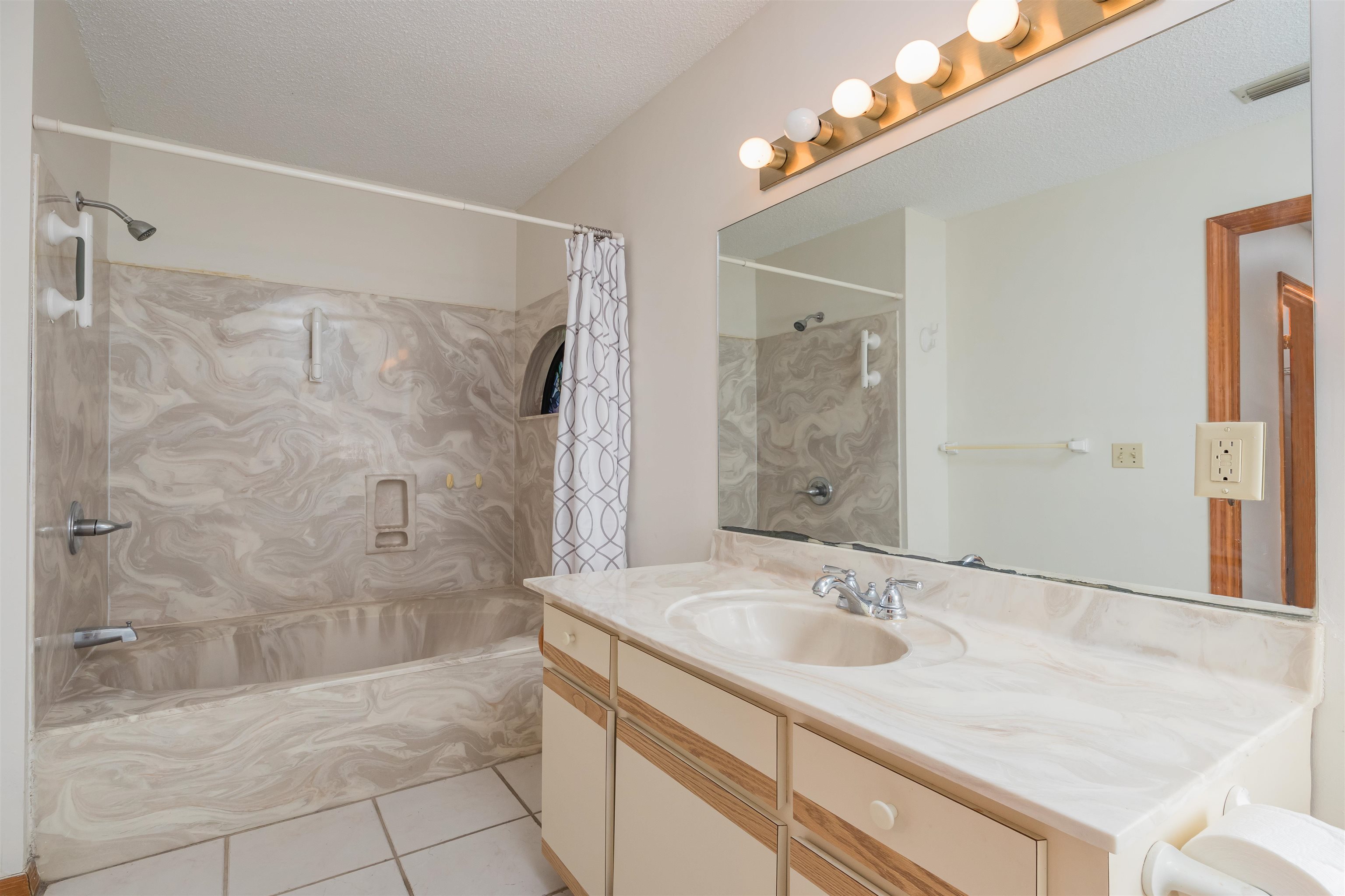 836 Queen Road St. Augustine, FL 32086 - Photo 19 of 26 a bathroom with a granite countertop sink a shower and a mirror