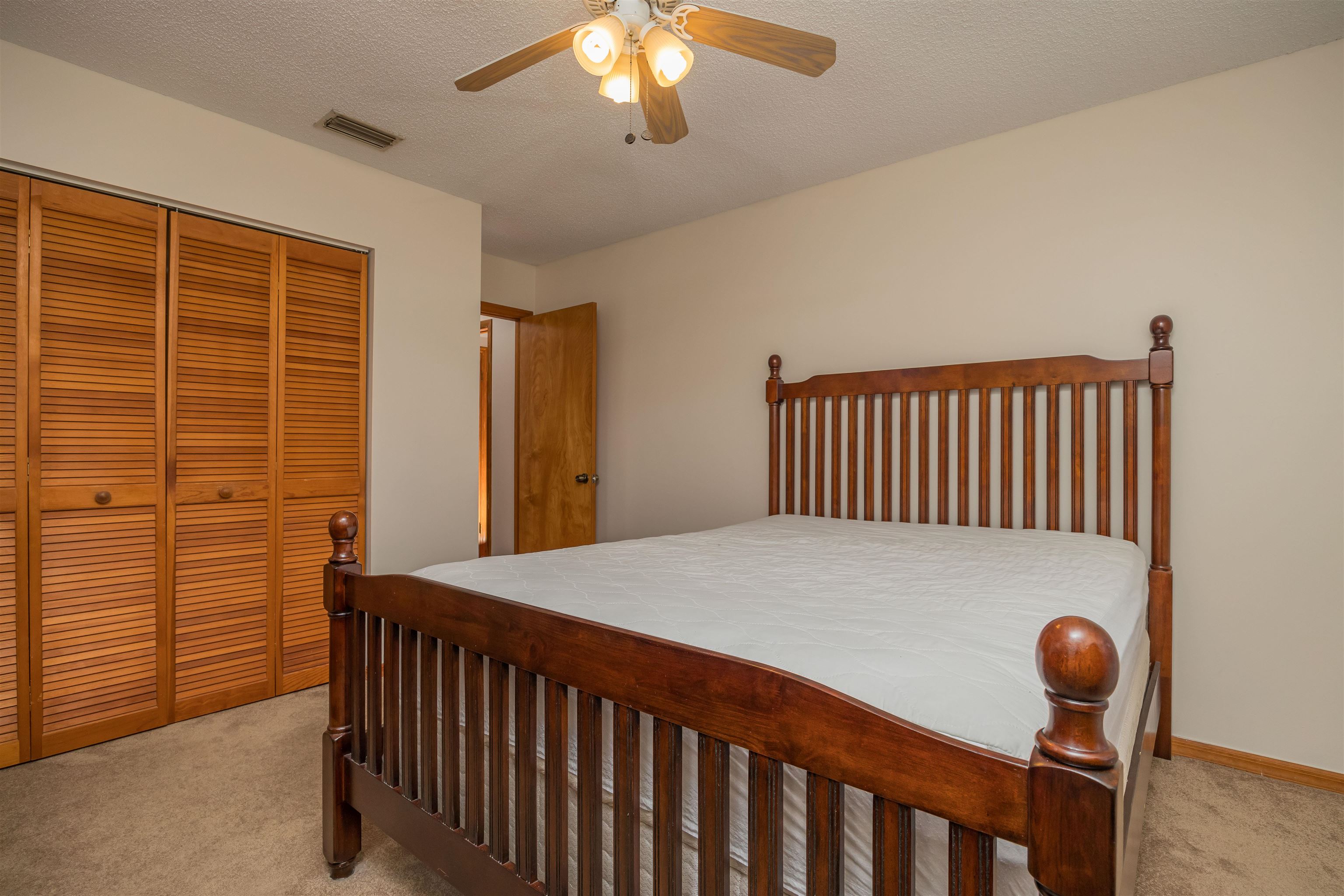 836 Queen Road St. Augustine, FL 32086 - Photo 22 of 26 a bedroom with a bed and a chandelier