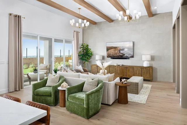 a living room with furniture and a chandelier