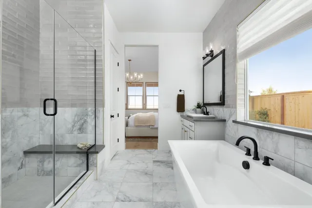 a bathroom with a double vanity sink mirror and shower