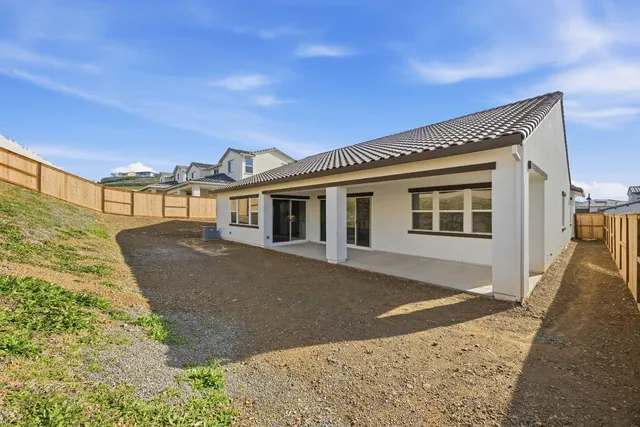 a front view of a house with a road