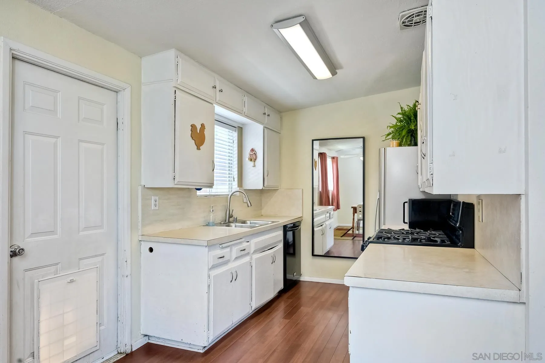 9267 Fairlawn Street Santee, CA 92071 - Photo 12 of 25 a kitchen with a white stove top oven and refrigerator
