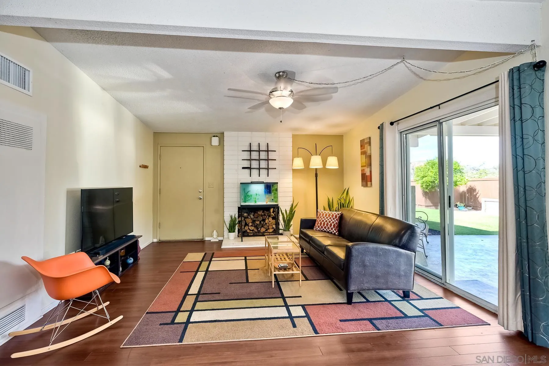 9267 Fairlawn Street Santee, CA 92071 - Photo 8 of 25 a living room with furniture a rug and a floor to ceiling window