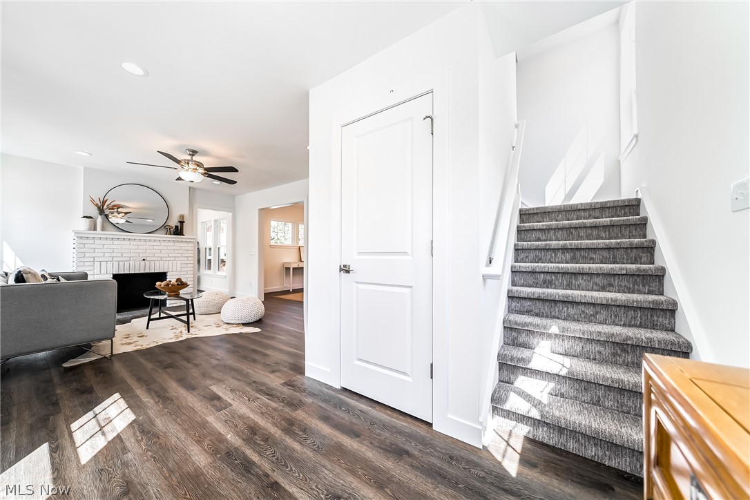 3959 Ardmore Road Cleveland Heights, OH 44121 - Photo 15 of 38 Stairs featuring dark hardwood / wood-style flooring, ceiling fan, and a fireplace