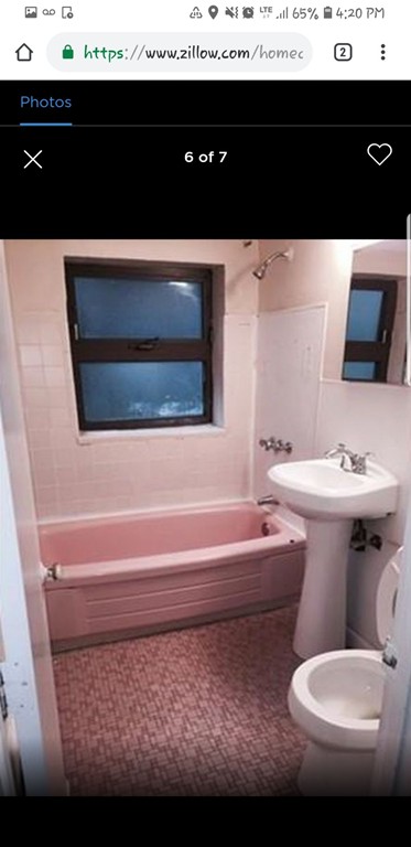 a bathroom with a toilet a sink and a mirror