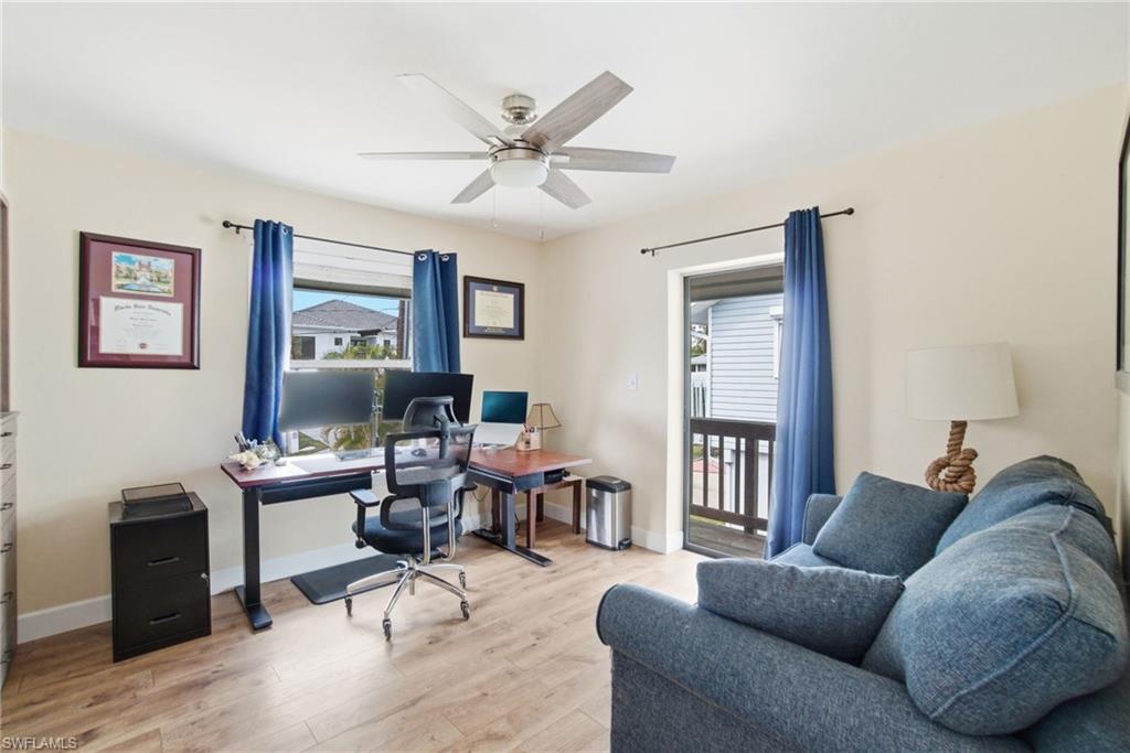 1286 Venetian Way Naples, FL 34110 - Photo 16 of 46 a living room with furniture a desk and chair with wooden floor