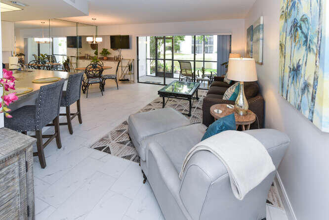1605 Highway 1, Unit B105 Jupiter, FL 33477 - Photo 13 of 30 a living room with furniture and a large window