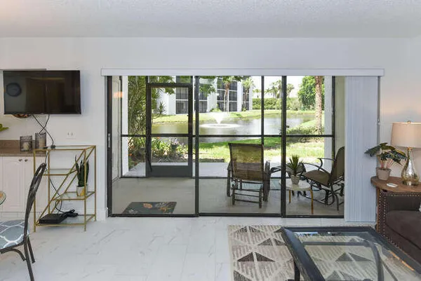 a view of a livingroom with furniture wooden floor and a flat screen tv