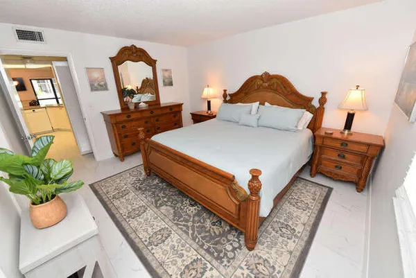 a bed room with a bed and a potted plant