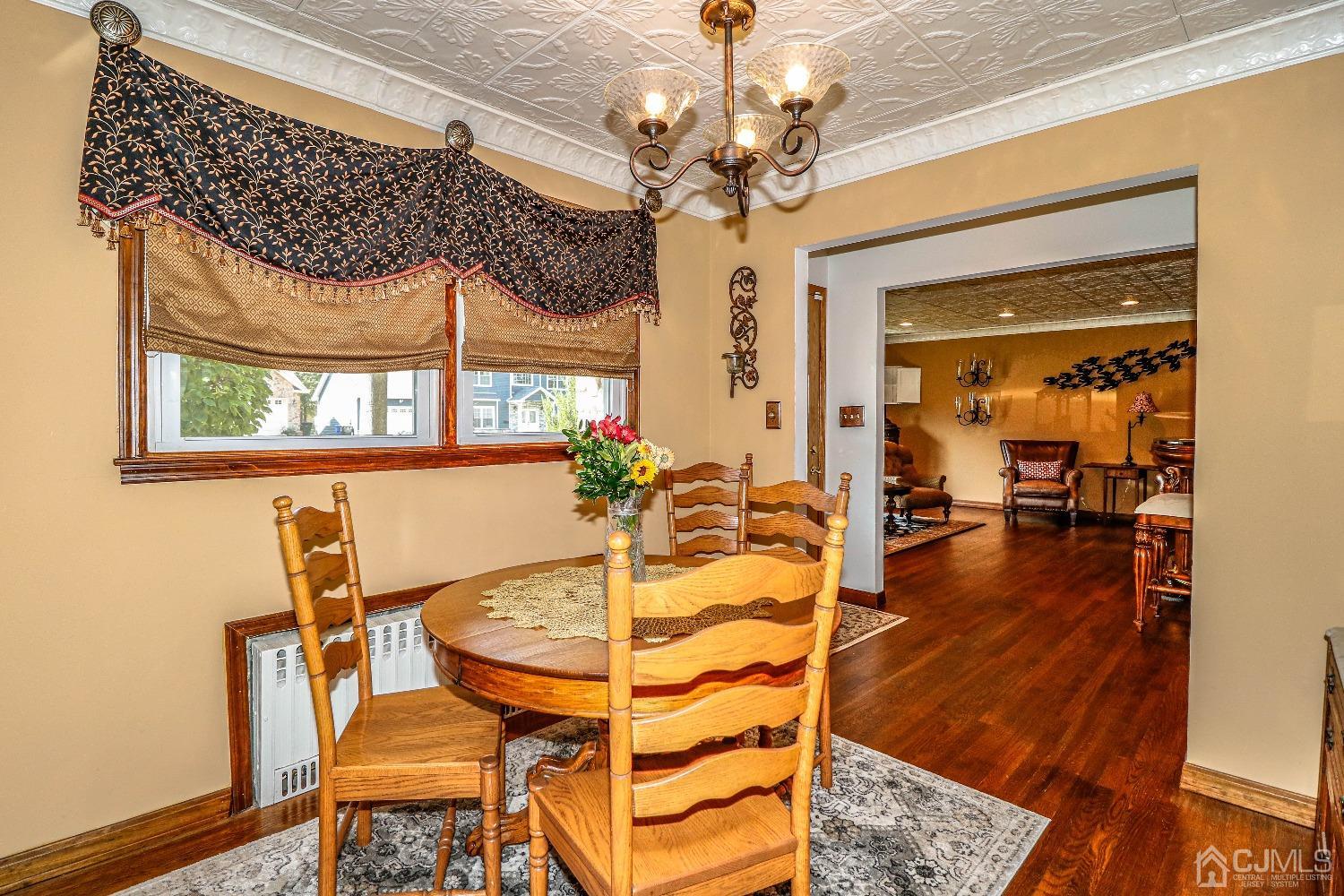 40 Highland Road Colonia, NJ 07067 - Photo 13 of 37 a view of a dining room with furniture wooden floor and a chandelier