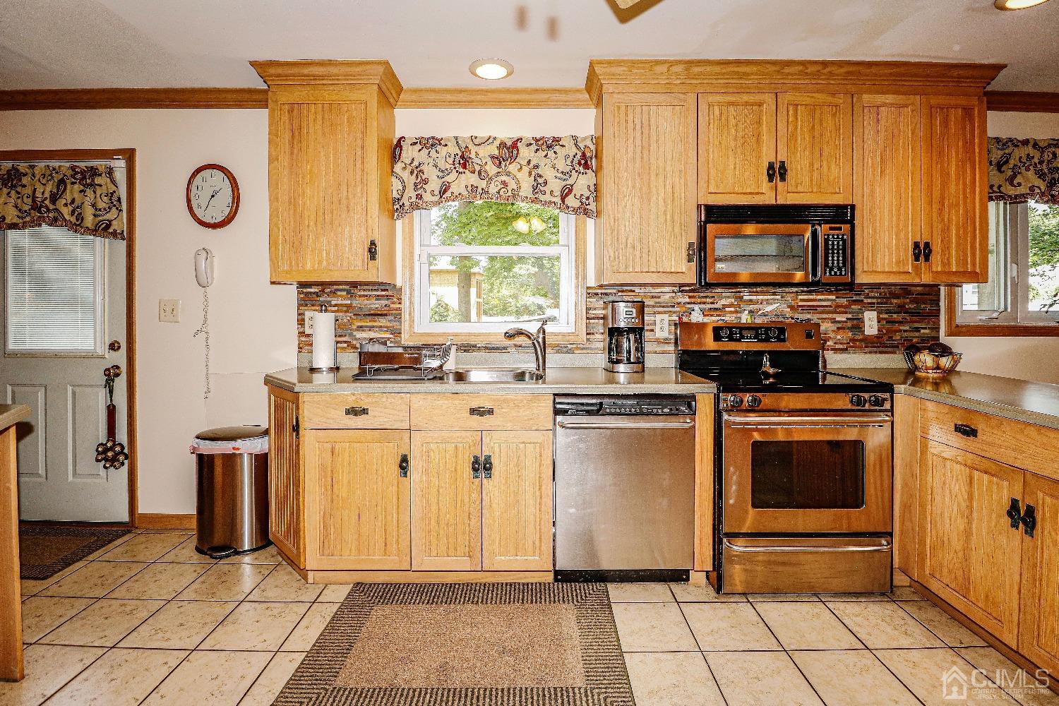 40 Highland Road Colonia, NJ 07067 - Photo 15 of 37 a kitchen with stainless steel appliances a stove a sink and a refrigerator