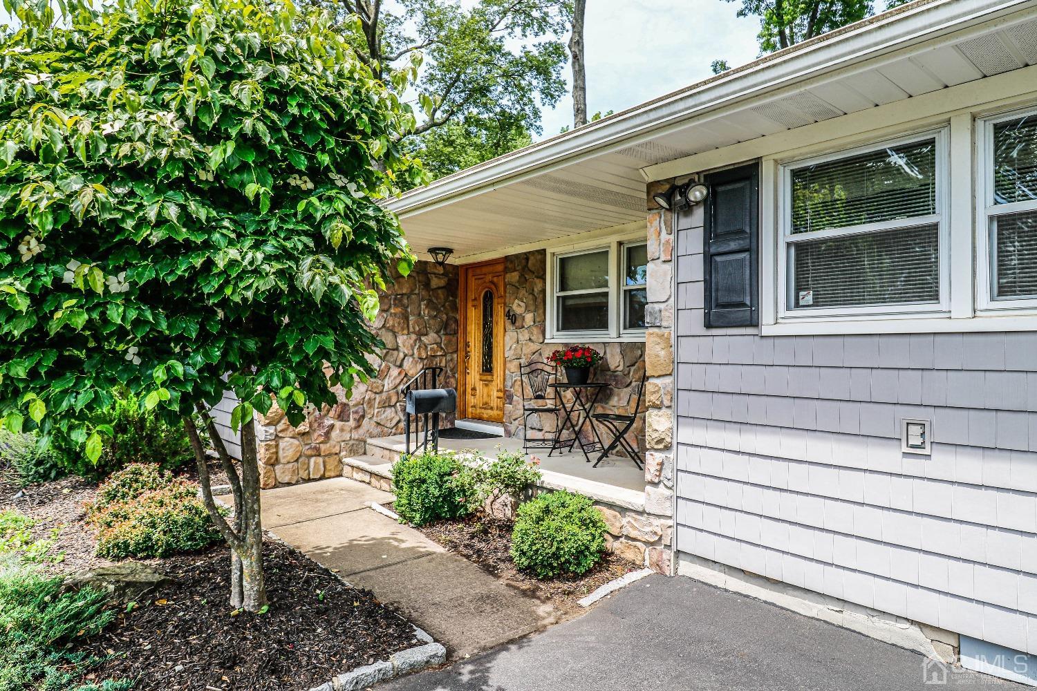 40 Highland Road Colonia, NJ 07067 - Photo 3 of 37 a view of house with backyard outdoor seating and green space