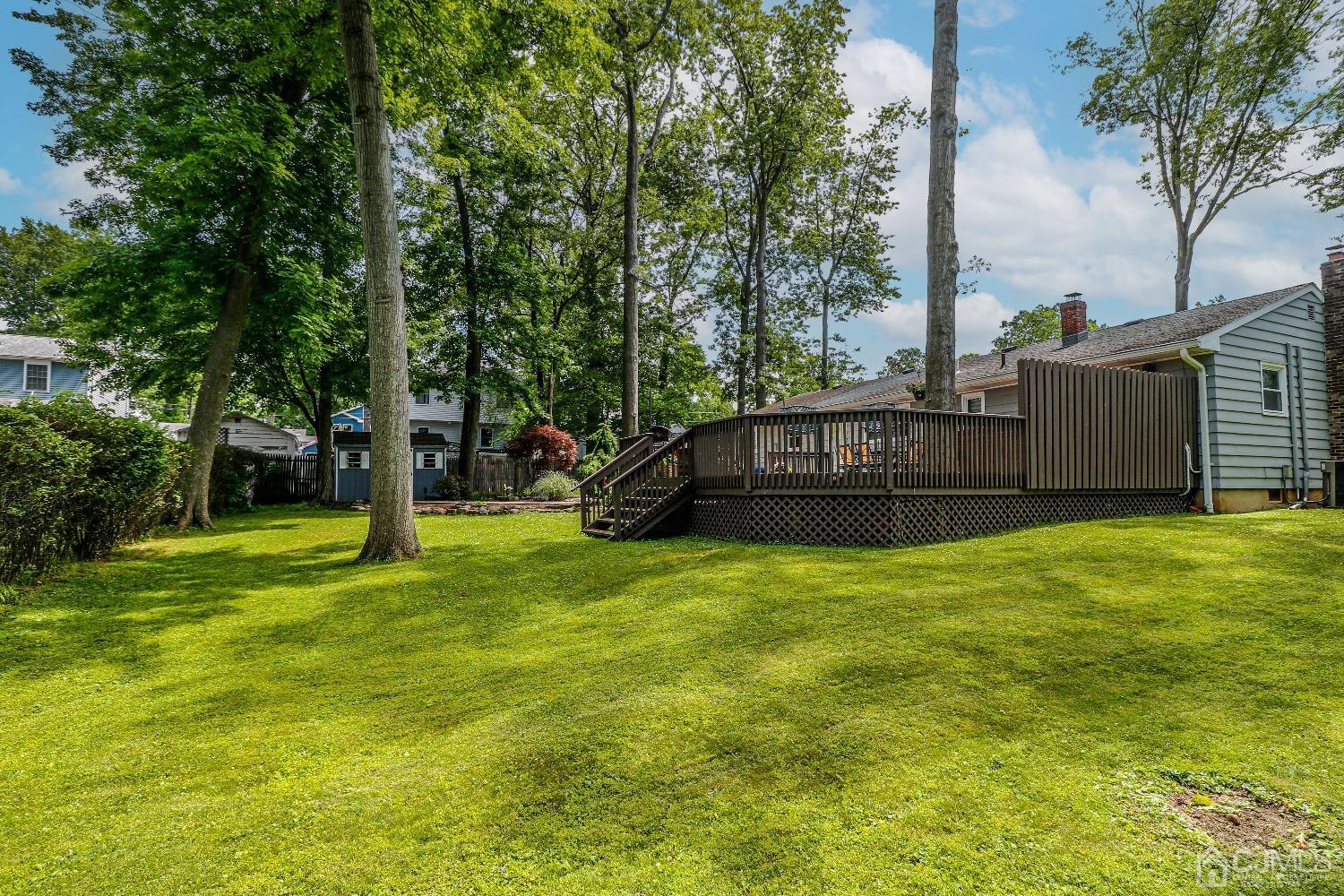 40 Highland Road Colonia, NJ 07067 - Photo 33 of 37 a view of a house with a big yard and large trees