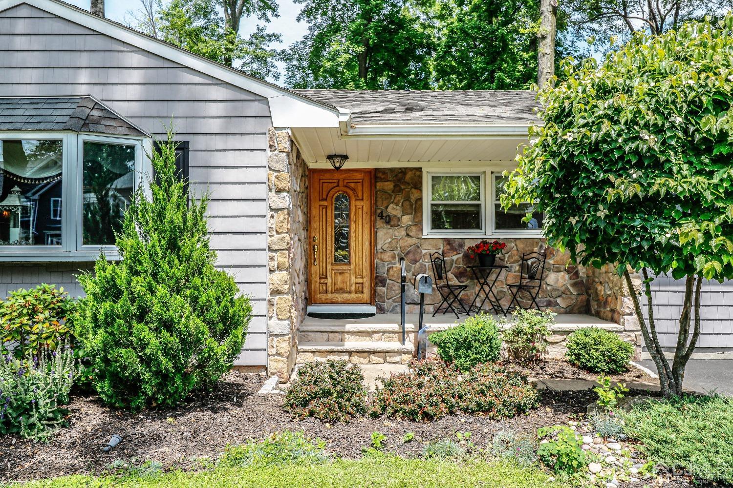 40 Highland Road Colonia, NJ 07067 - Photo 4 of 37 a view of a house with potted plants and a large tree