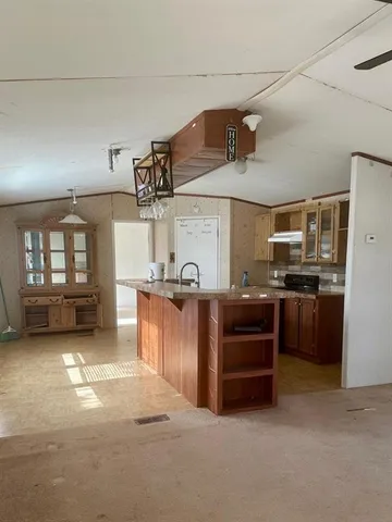 a view of a kitchen with furniture and windows