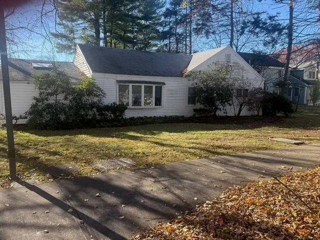 a view of a house with swimming pool and sitting area