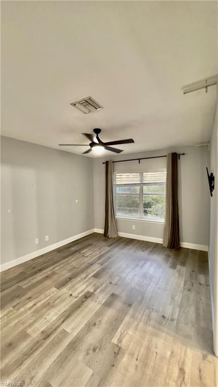 19550 Bowring Park Road, Unit 103 Fort Myers, FL 33967 - Photo 14 of 22 a view of empty room with wooden floor