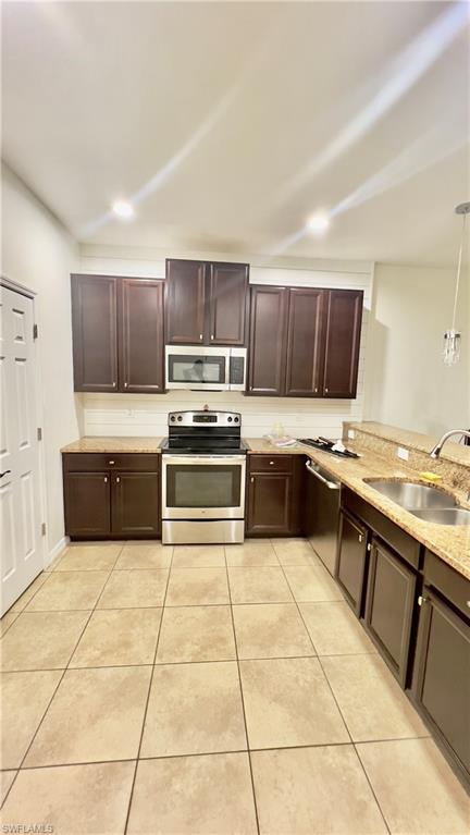 19550 Bowring Park Road, Unit 103 Fort Myers, FL 33967 - Photo 4 of 22 a kitchen with a stove a sink and a microwave