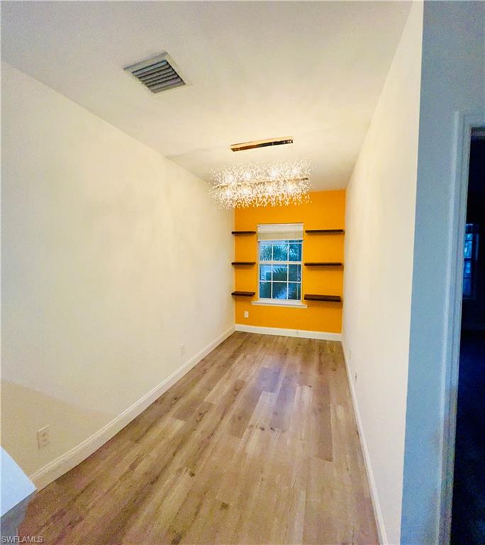19550 Bowring Park Road, Unit 103 Fort Myers, FL 33967 - Photo 10 of 22 a view of a room with wooden floor and a window