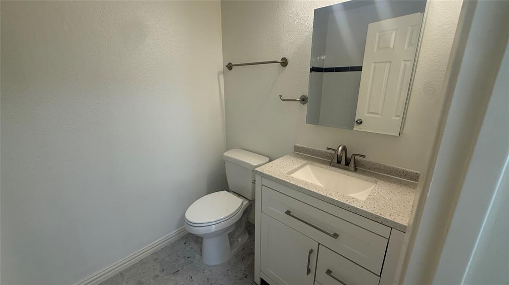 500 East Riverside Drive, Unit 132 Austin, TX 78704 - Photo 12 of 31 a bathroom with a granite countertop sink toilet and mirror