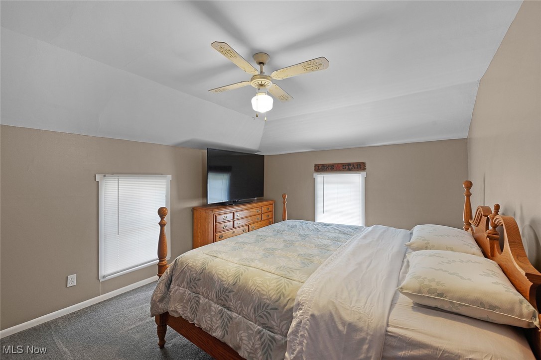 11794 Vermilion Road Oberlin, OH 44074 - Photo 25 of 34 Bedroom featuring baseboards, lofted ceiling, carpet flooring, and a ceiling fan