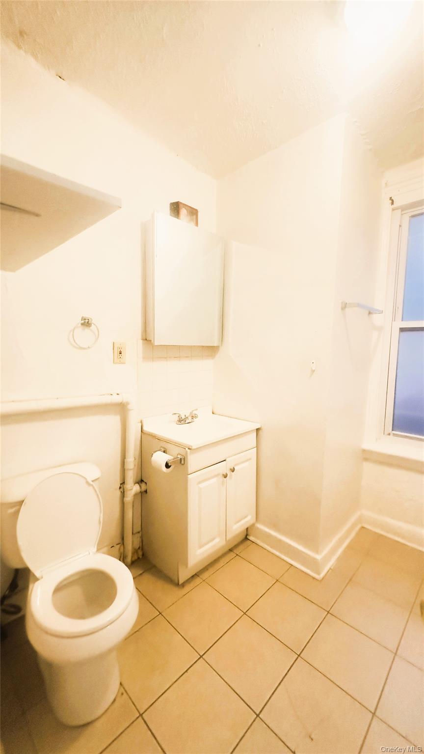 26 Du Bois Avenue, Unit 2 Poughkeepsie, NY 12601 - Photo 8 of 9 a bathroom with a granite countertop toilet and a sink