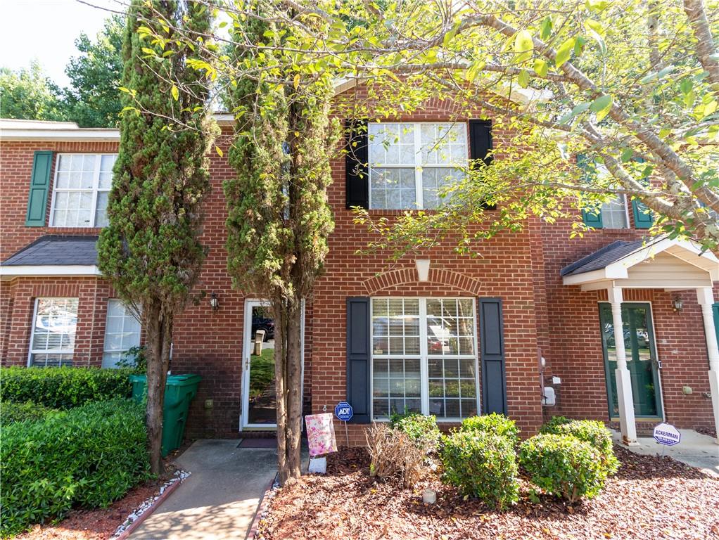 3769 Waldrop Lane Decatur, GA 30034 - Photo 1 of 1 view of a brick house with a large windows and a large tree