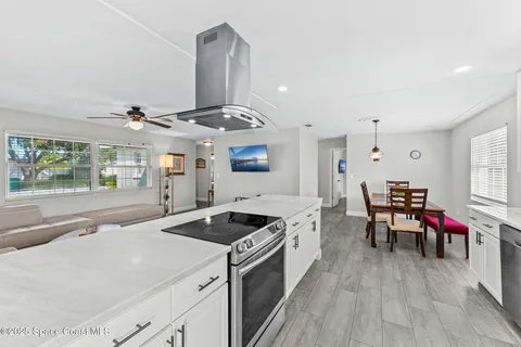 a kitchen with stove and wooden floor
