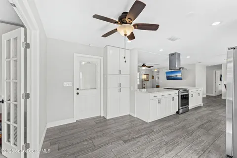 a kitchen with stainless steel appliances kitchen island granite countertop a refrigerator and a stove