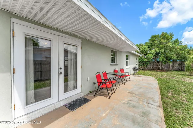 a view of a backyard with a table and chairs