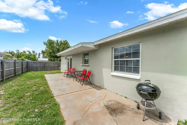 a view of a house with backyard porch and sitting area