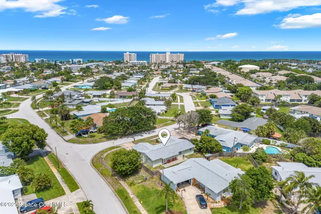 an aerial view of residential houses with outdoor space