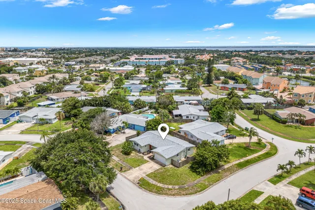 an aerial view of residential houses with outdoor space and street view