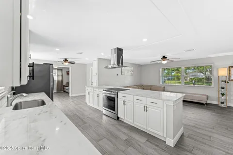 a kitchen with a sink stove and refrigerator