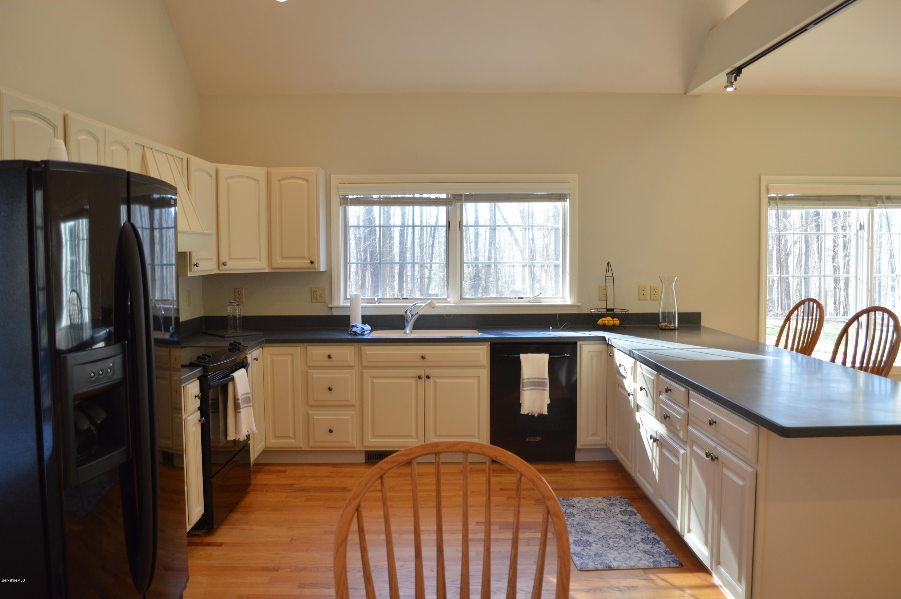 2307 Jacobs Ladder Road Becket, MA 01223 - Photo 17 of 55 a kitchen with stainless steel appliances granite countertop a sink a stove a refrigerator cabinets and a window