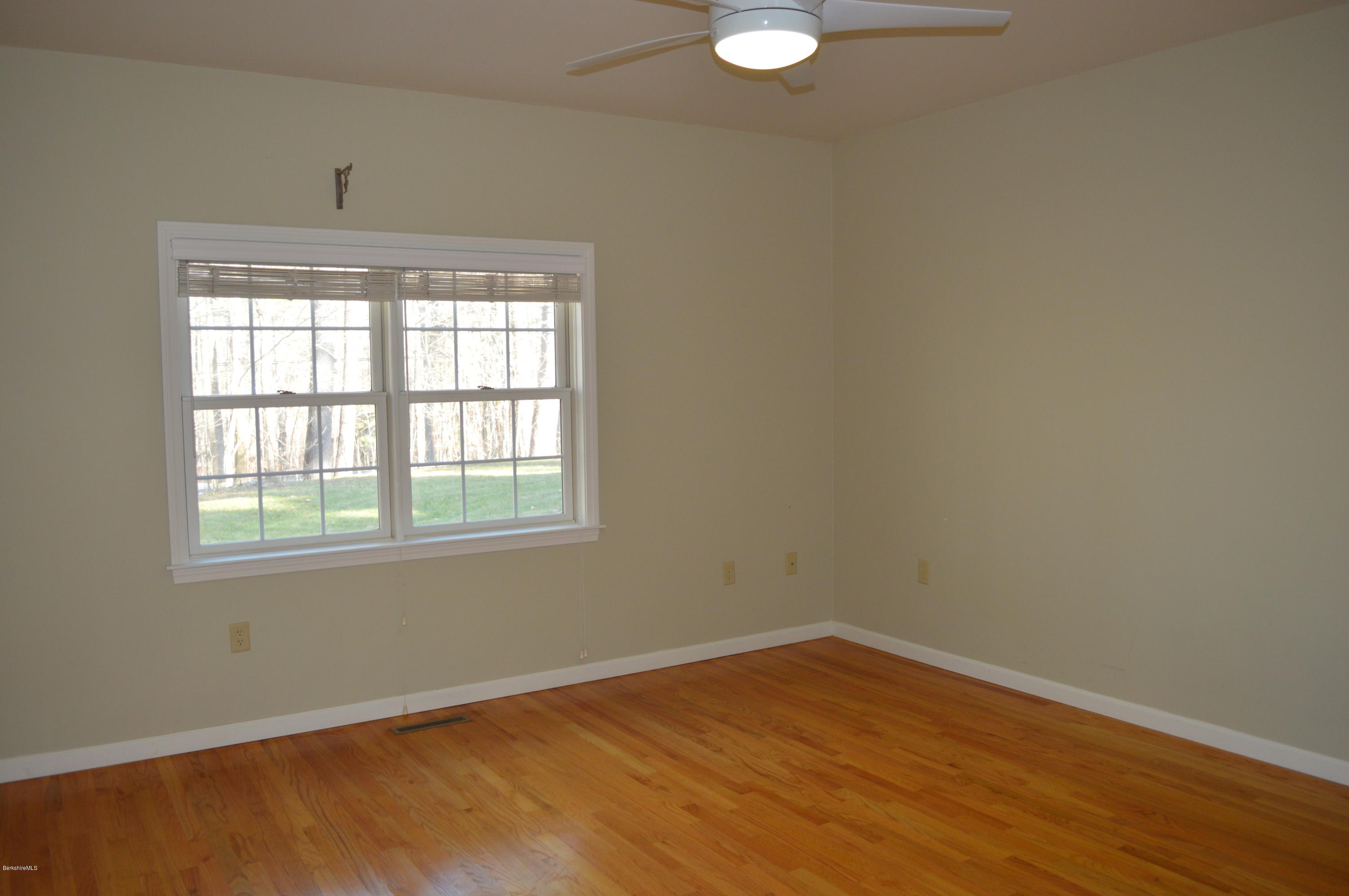 2307 Jacobs Ladder Road Becket, MA 01223 - Photo 22 of 55 an empty room with wooden floor and windows