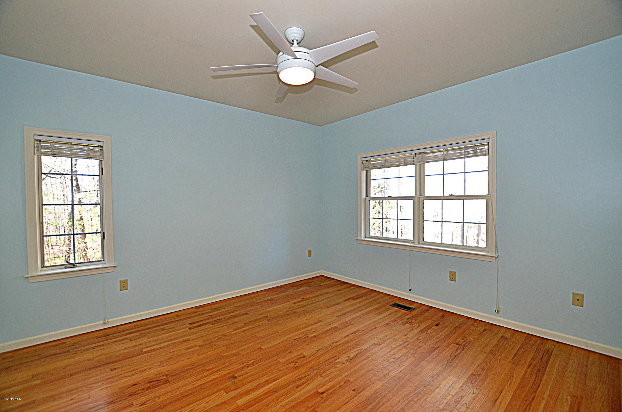 2307 Jacobs Ladder Road Becket, MA 01223 - Photo 23 of 55 an empty room with wooden floor and windows