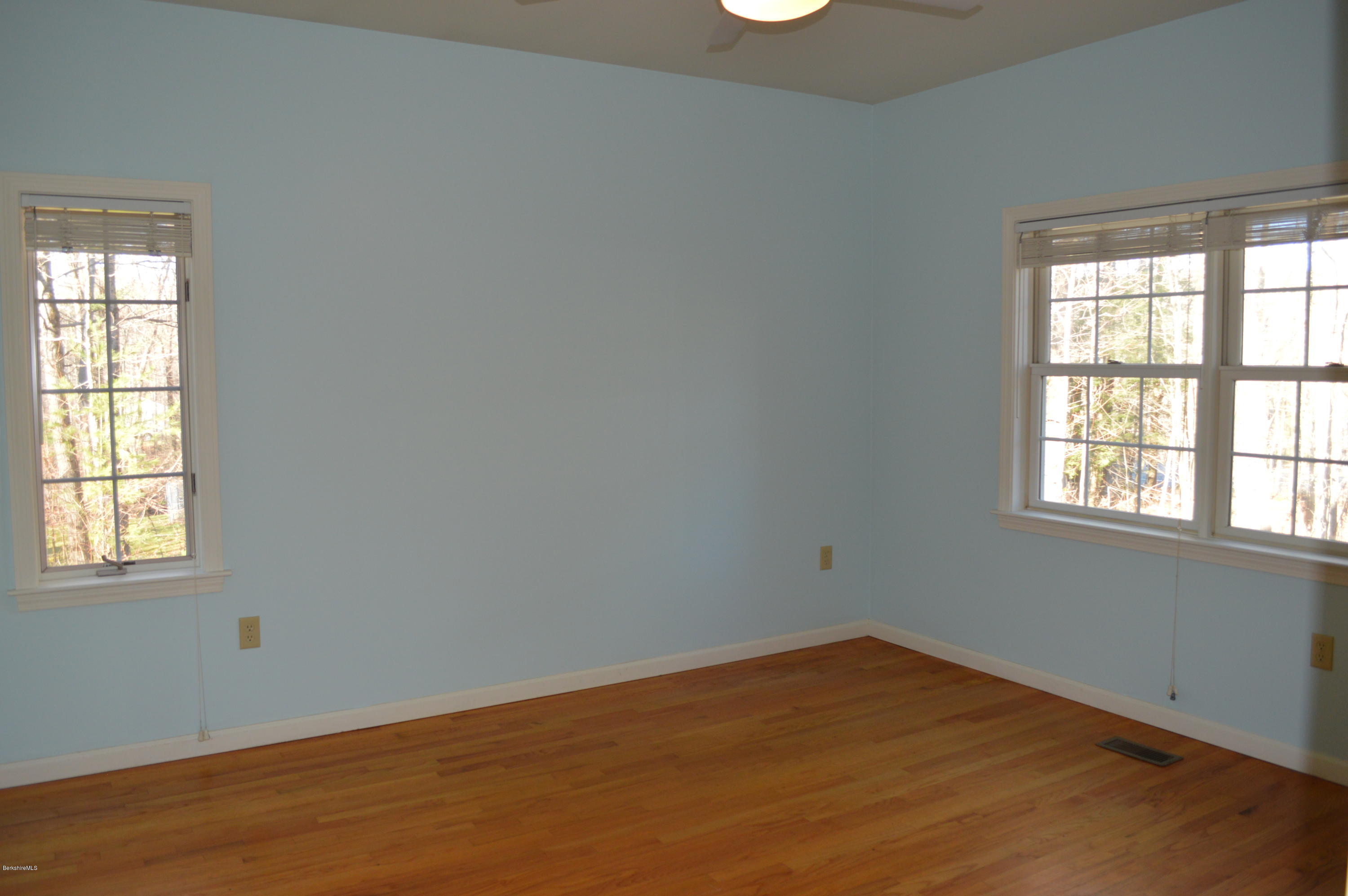 2307 Jacobs Ladder Road Becket, MA 01223 - Photo 24 of 55 an empty room with wooden floor and windows
