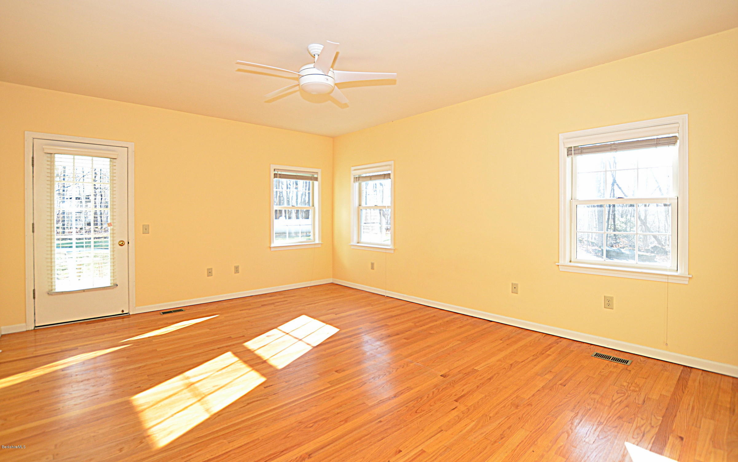 2307 Jacobs Ladder Road Becket, MA 01223 - Photo 27 of 55 a view of an empty room with wooden floor and a window