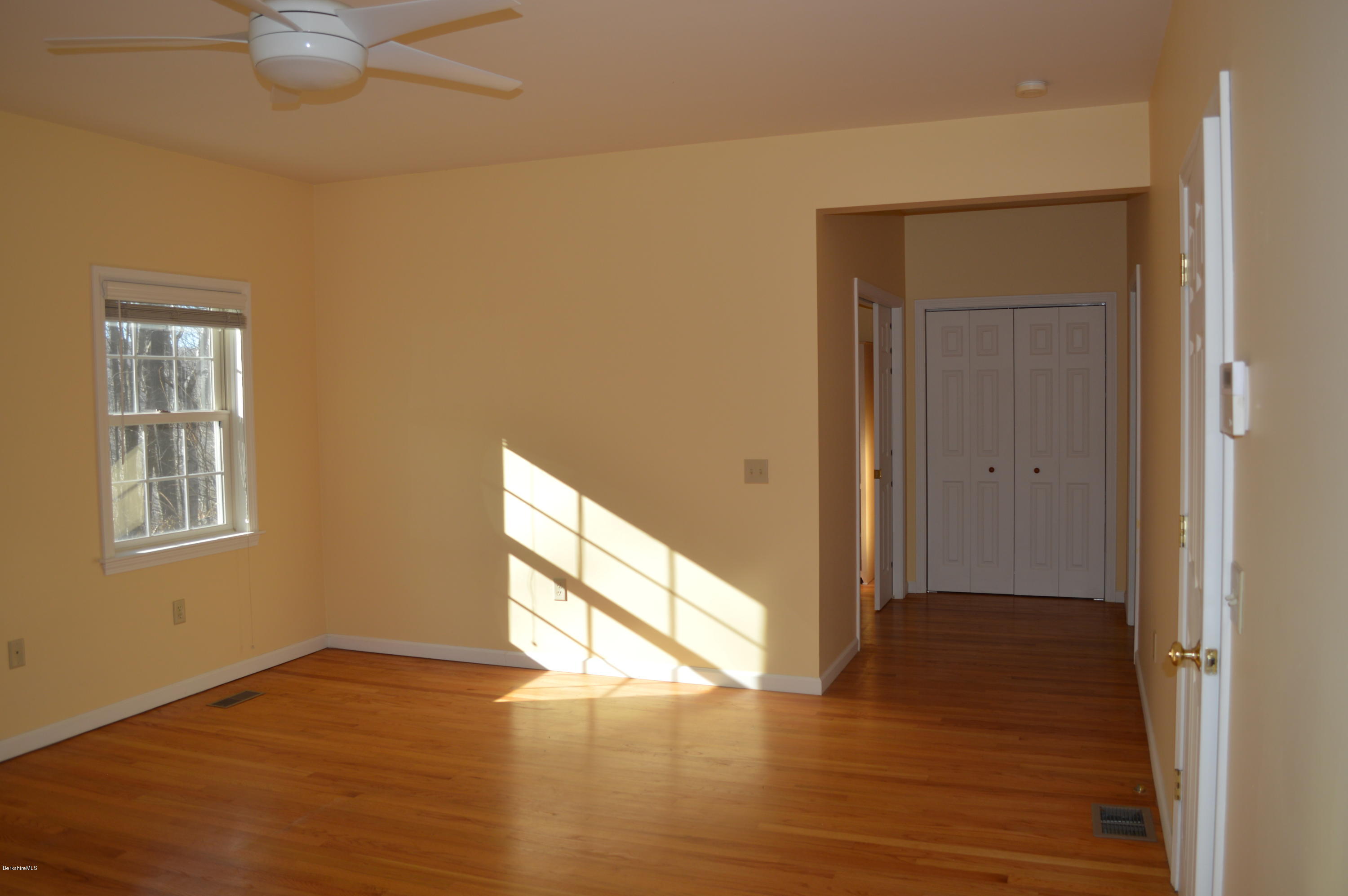 2307 Jacobs Ladder Road Becket, MA 01223 - Photo 29 of 55 a view of an empty room with wooden floor and a window