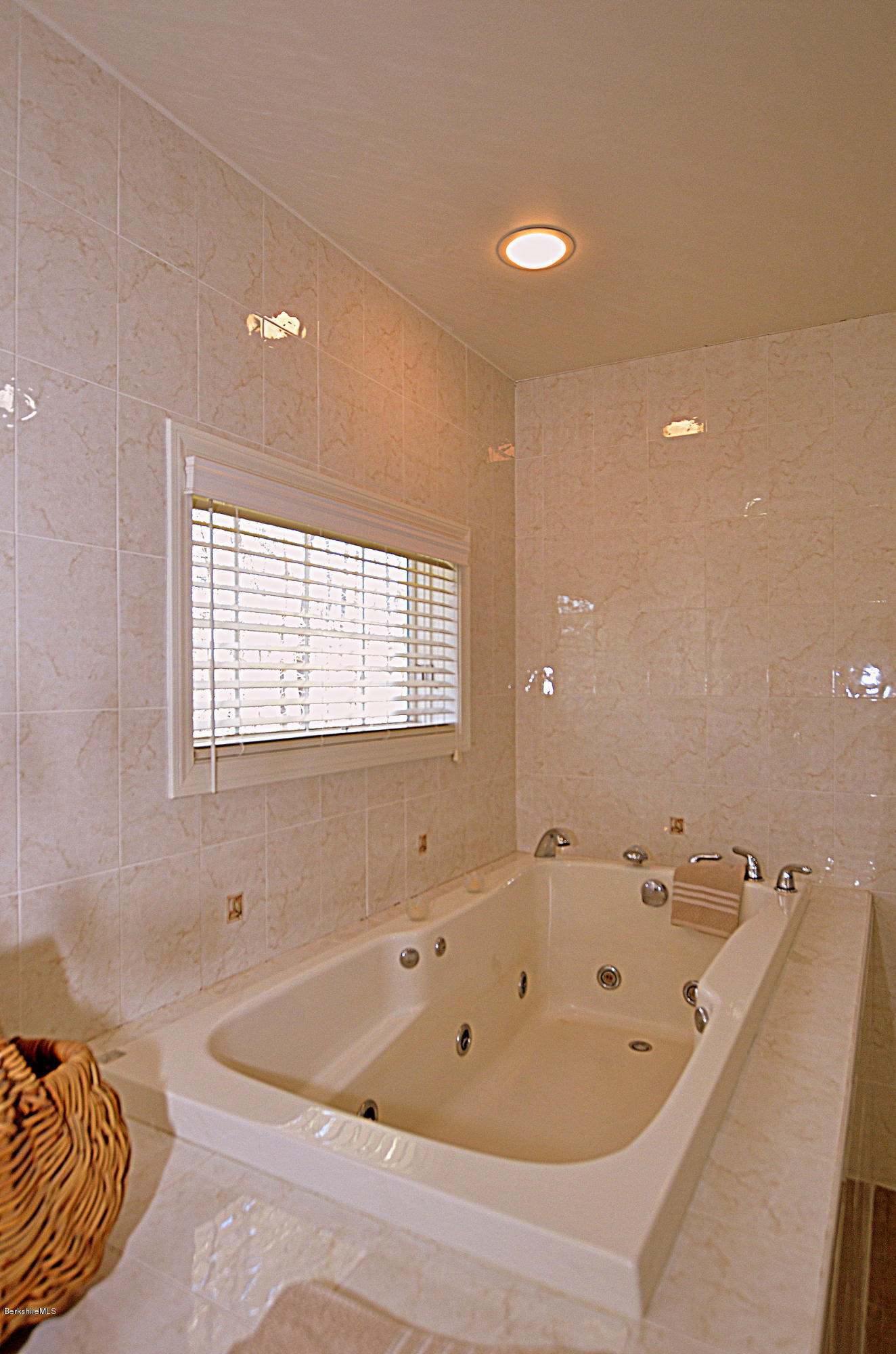 2307 Jacobs Ladder Road Becket, MA 01223 - Photo 32 of 55 a bath tub sitting in a bathroom next to a window