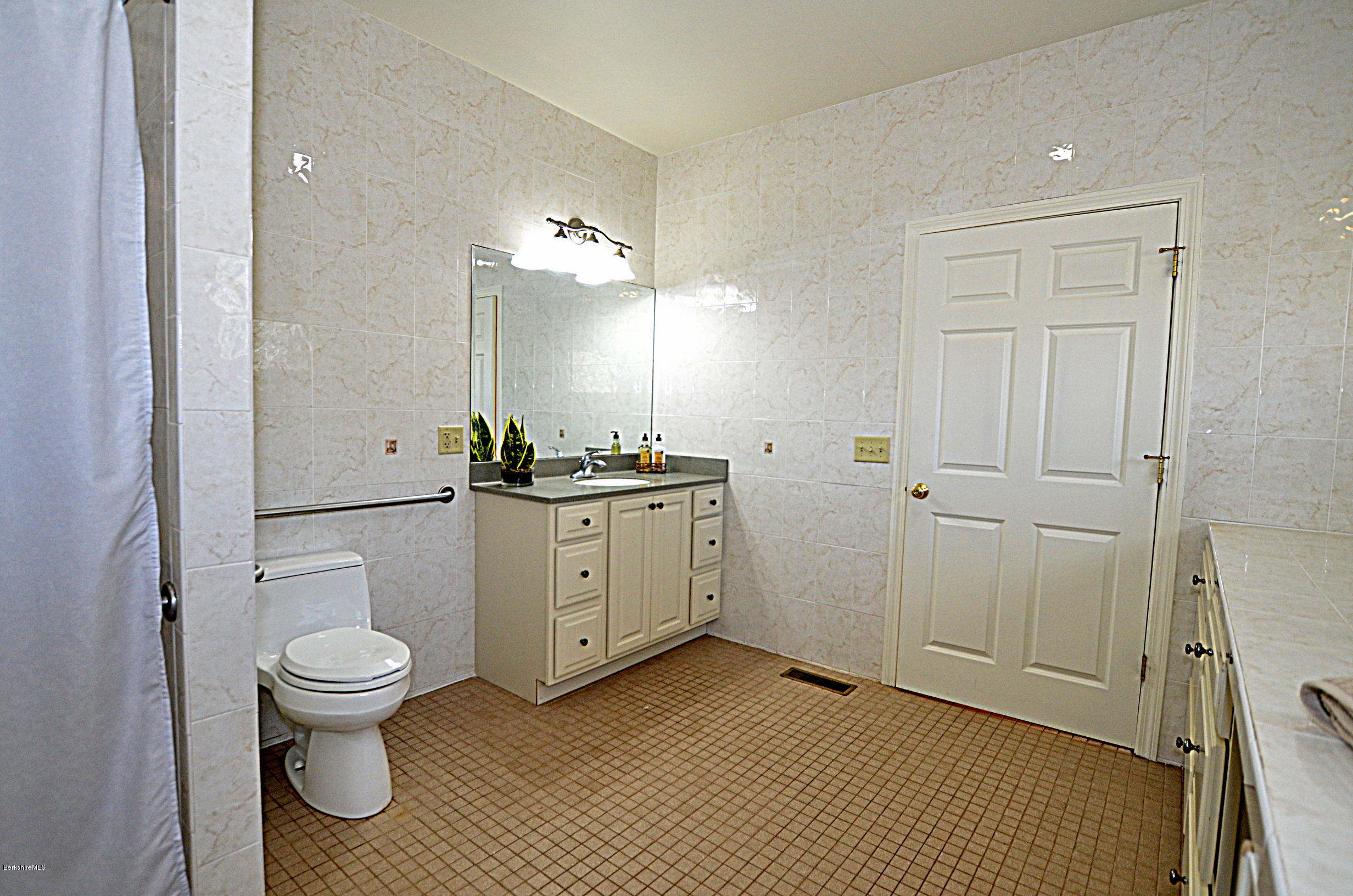 2307 Jacobs Ladder Road Becket, MA 01223 - Photo 33 of 55 a bathroom with a toilet a sink and a mirror