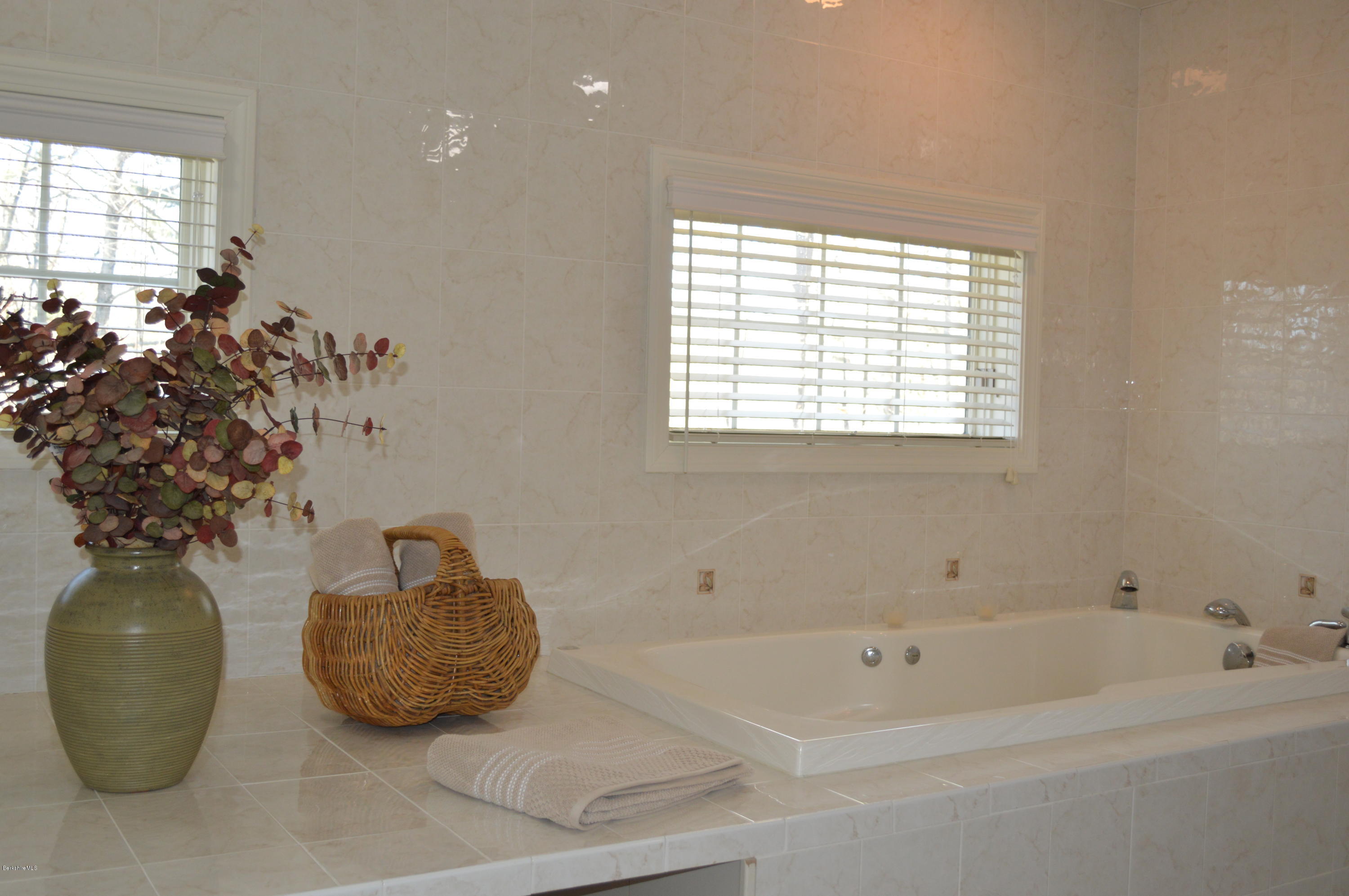 2307 Jacobs Ladder Road Becket, MA 01223 - Photo 35 of 55 a bathroom with a bathtub sink and window