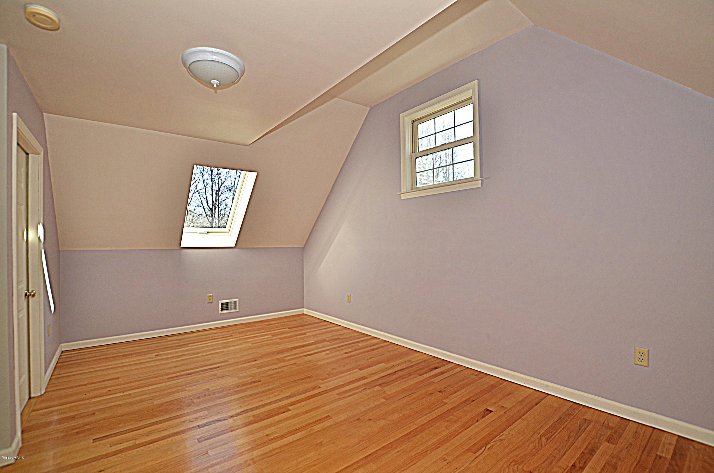 2307 Jacobs Ladder Road Becket, MA 01223 - Photo 38 of 55 a view of an empty room with wooden floor and a window